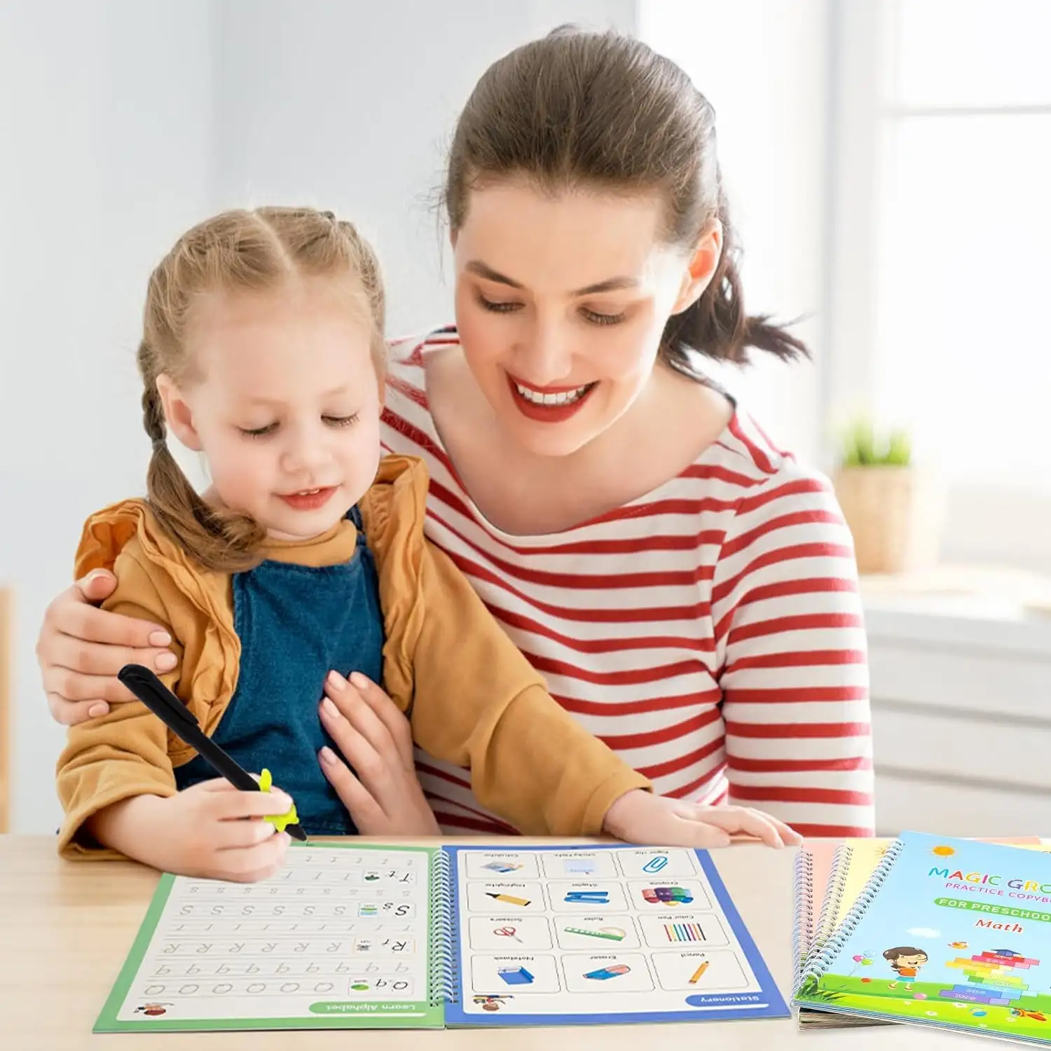 Mother helping young child practice handwriting with Magic Copybook at a table, promoting early education.
