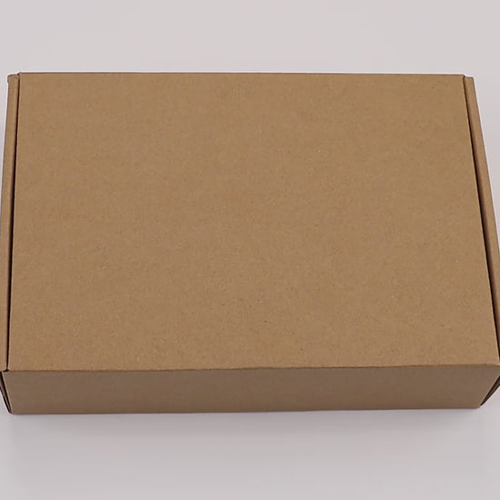Unboxing video revealing Magic Copybook package contents including educational books, pens, and refills.